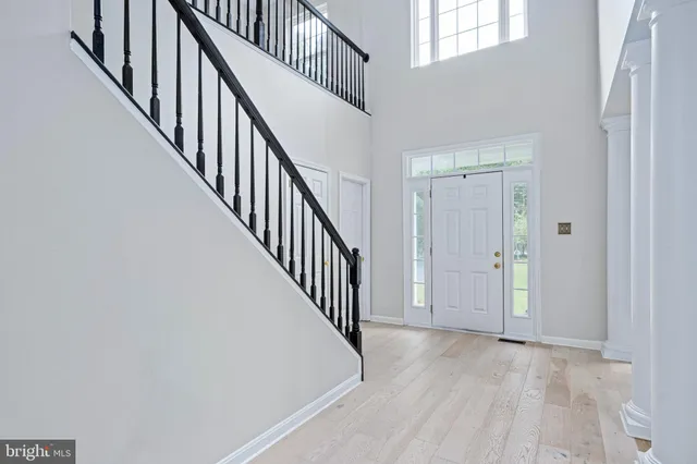 a view of a hallway with wooden floor and closet