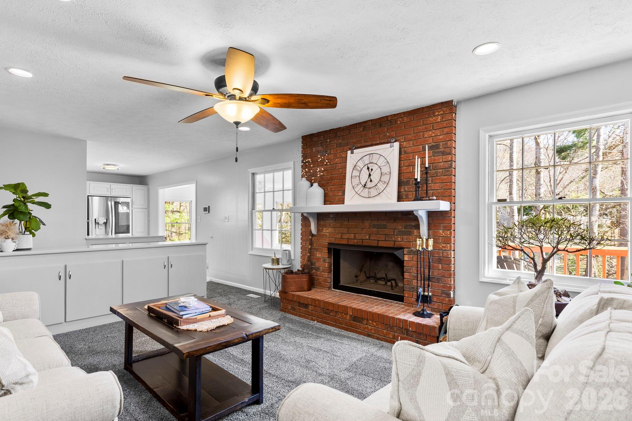 15 Blueberry Hill Road Asheville, NC 28804 - Photo 14 of 35 a living room with furniture a fireplace and a chandelier