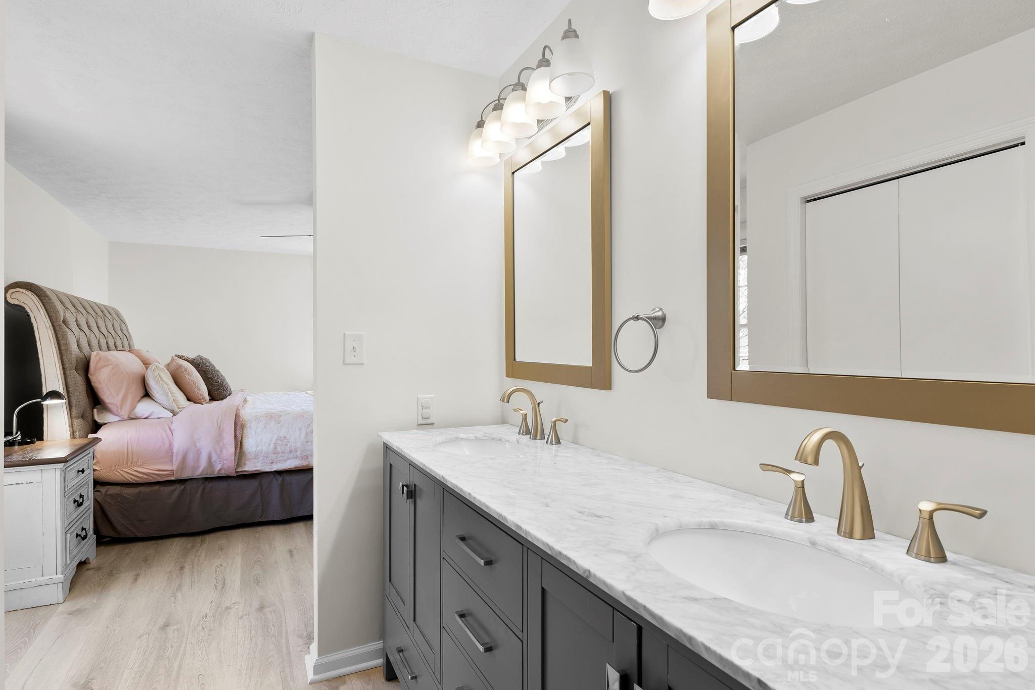 15 Blueberry Hill Road Asheville, NC 28804 - Photo 20 of 35 a en suite bathroom with double vanity sinks and a mirror