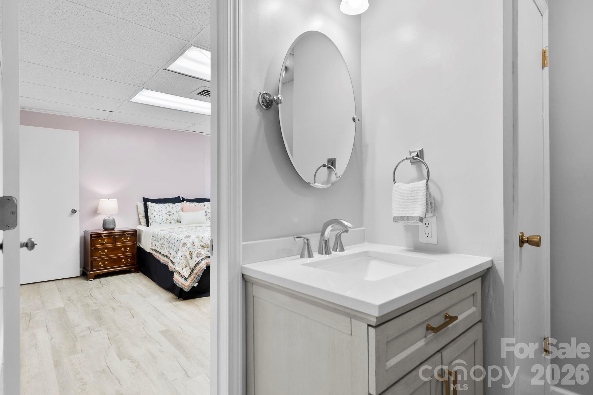 15 Blueberry Hill Road Asheville, NC 28804 - Photo 24 of 35 a en suite bathroom with a sink and a mirror