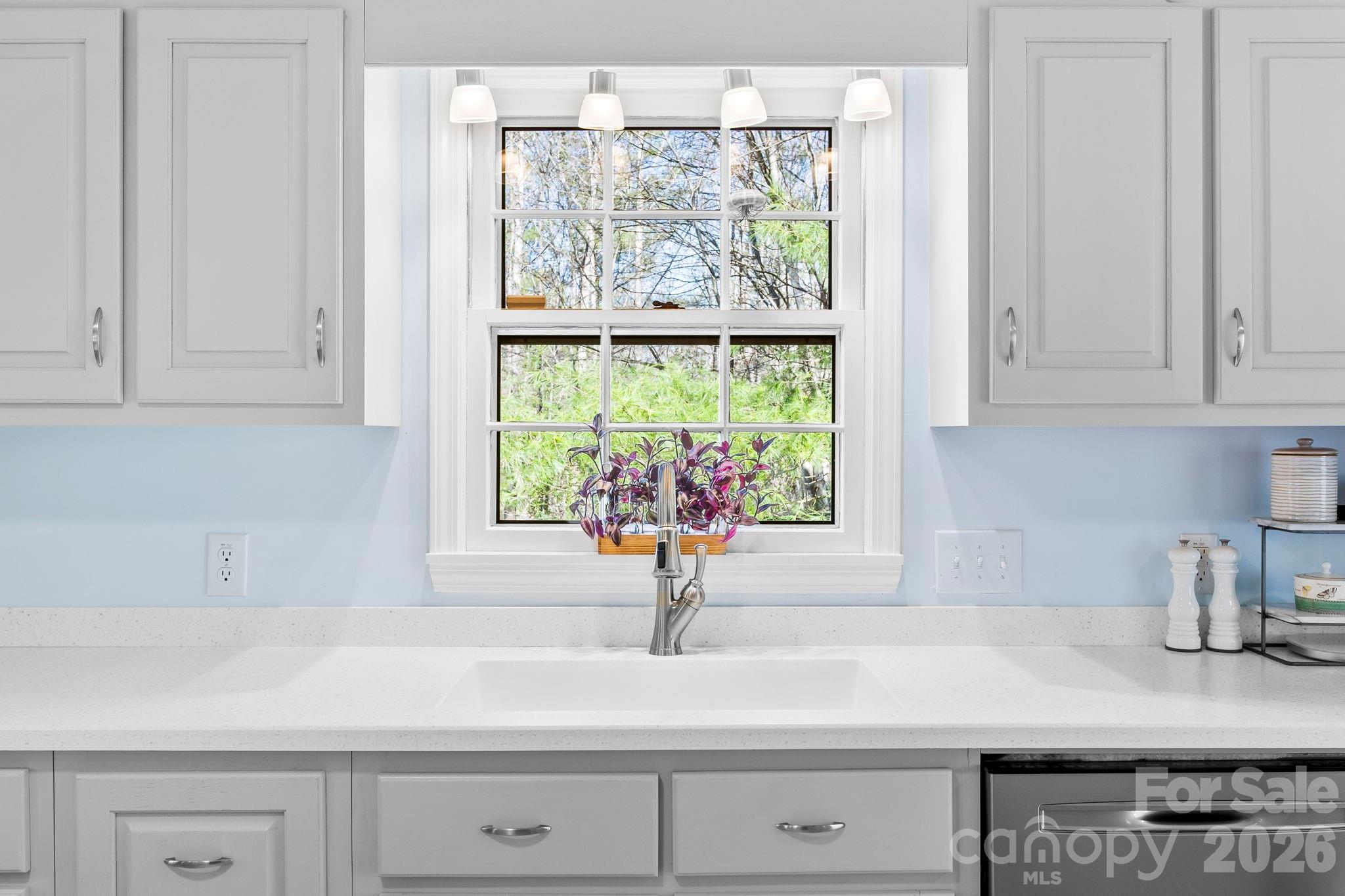 15 Blueberry Hill Road Asheville, NC 28804 - Photo 7 of 35 a kitchen with stainless steel appliances white cabinets and a window