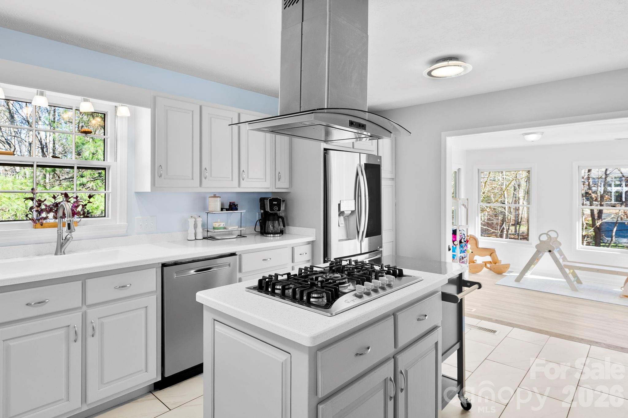 15 Blueberry Hill Road Asheville, NC 28804 - Photo 8 of 35 a kitchen with a stove and white cabinets