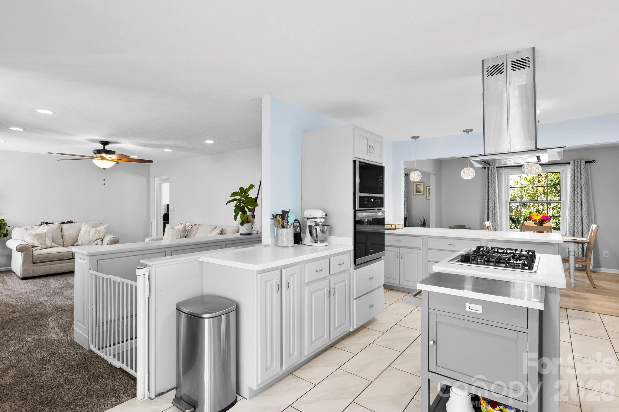 15 Blueberry Hill Road Asheville, NC 28804 - Photo 9 of 35 a kitchen with a stove a sink and a refrigerator