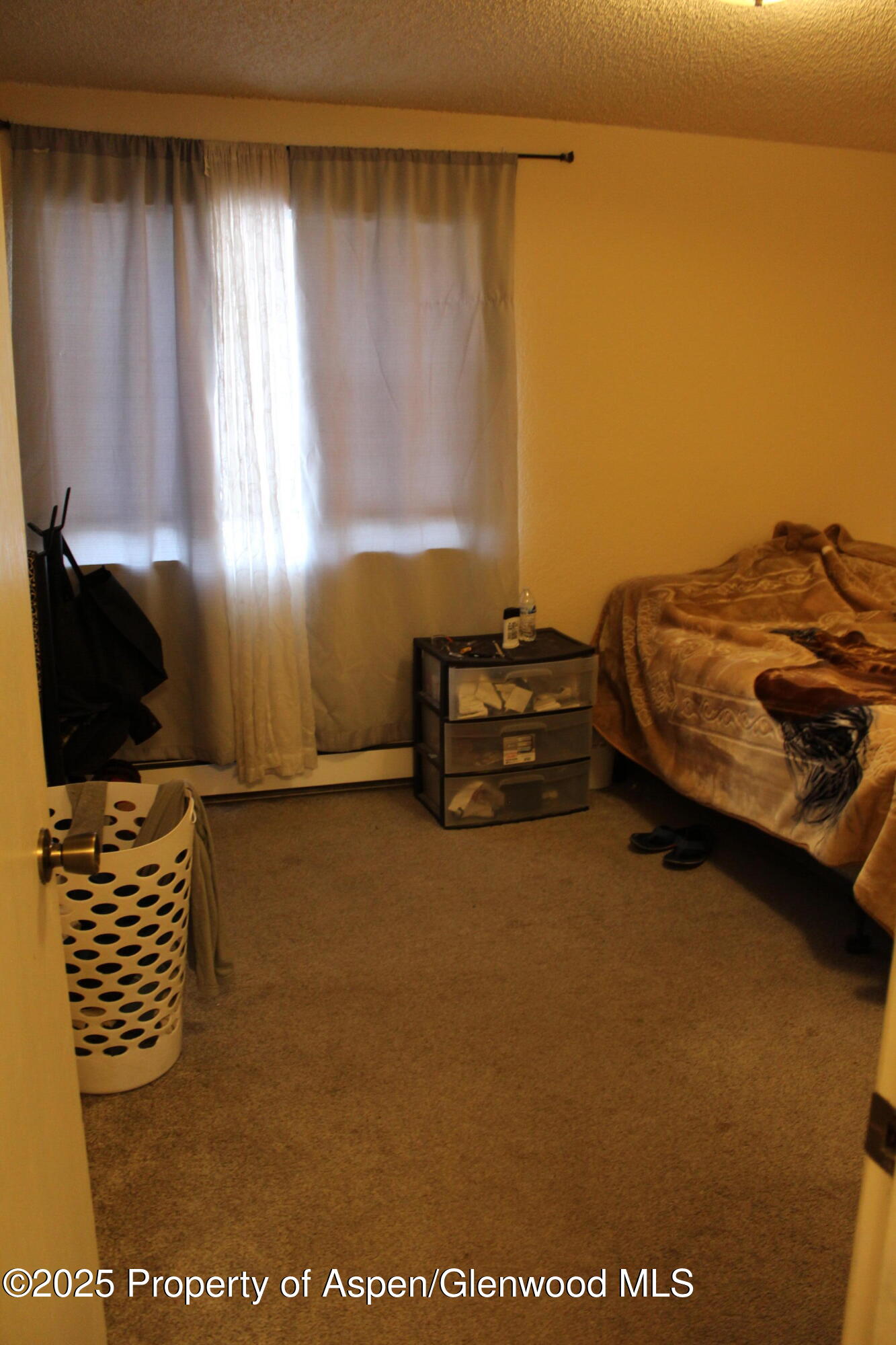 2401 Rail Avenue Rifle, CO 81650 - Photo 7 of 8 a bedroom with a bed and a window