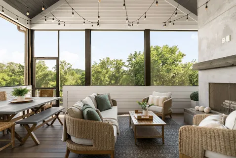 a living room with furniture and a floor to ceiling window