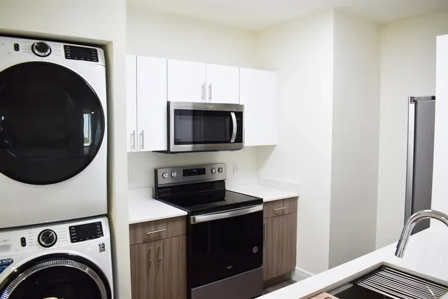 a view of kitchen sink and a washer dryer