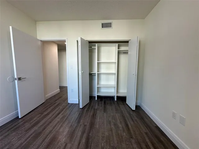 a room view with wooden floor and closet