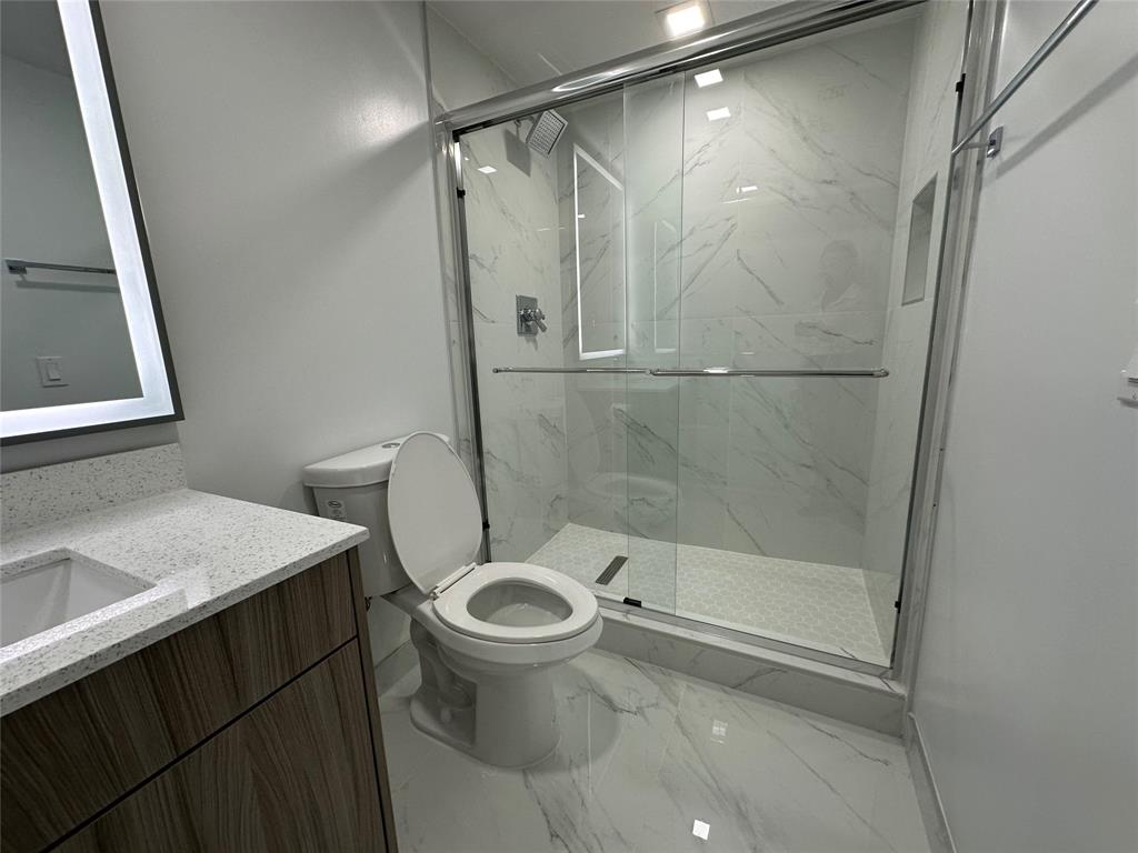 110 Southwest 12th Street, Unit 902 Miami, FL 33130 - Photo 17 of 25 a bathroom with a sink and a mirror