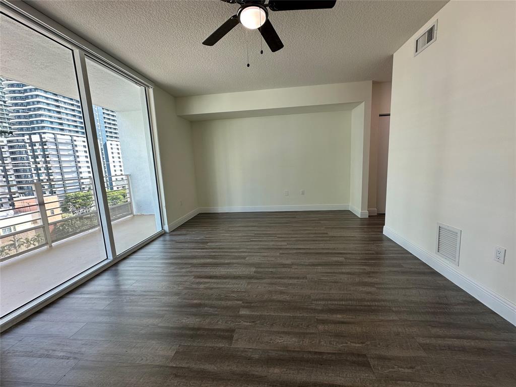 110 Southwest 12th Street, Unit 902 Miami, FL 33130 - Photo 19 of 25 a view of an empty room with wooden floor and a window