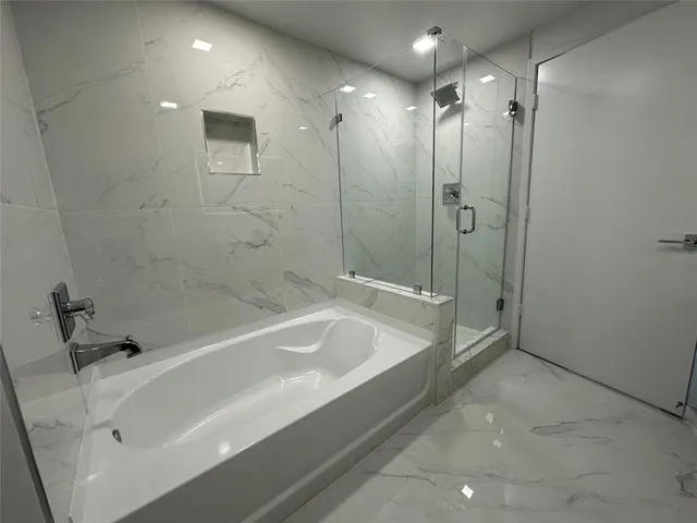 a bathroom with a tub and a shower