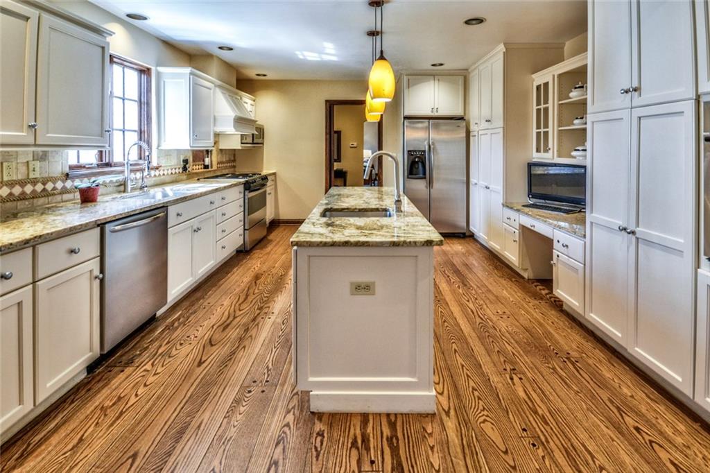 700 Fairview Road Fox Chapel, PA 15238 - Photo 4 of 25 Kitchen with Granite and Stainless Steel Appliances. 2 DS, 2 Oven, 2 Sinks, Pantry Cabinet, desk, beautiful hardwood floors.