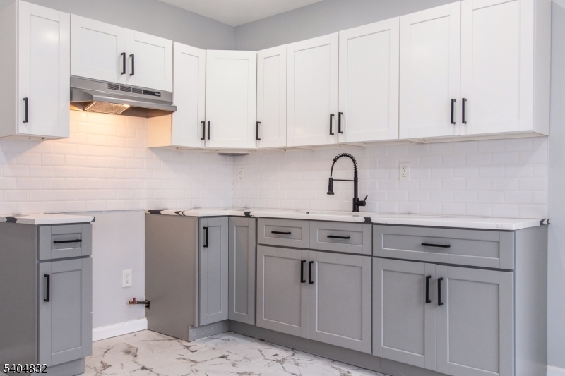 662 Mt Prospect Avenue Newark, NJ 07104 - Photo 3 of 15 a kitchen with white cabinets and white appliances