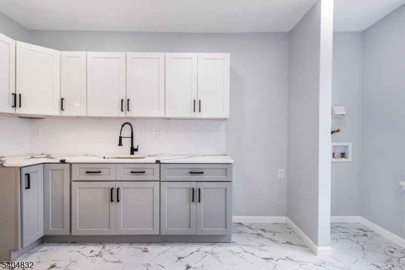 662 Mt Prospect Avenue Newark, NJ 07104 - Photo 4 of 15 a kitchen with stainless steel appliances granite countertop a sink stove and cabinets