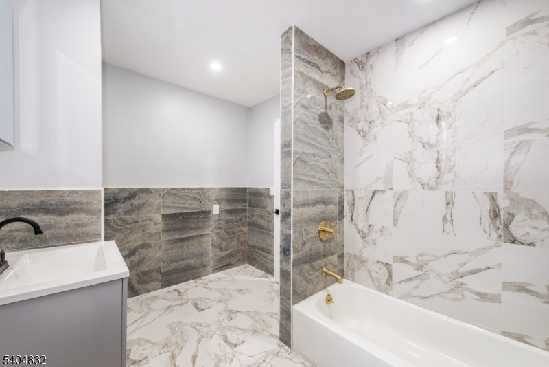 662 Mt Prospect Avenue Newark, NJ 07104 - Photo 5 of 15 a bathroom with a bathtub and shower