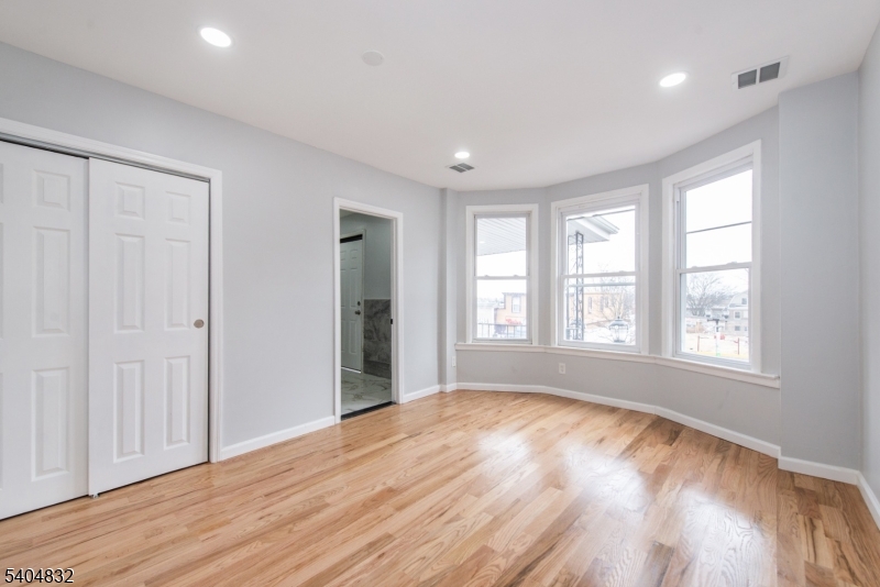 662 Mt Prospect Avenue Newark, NJ 07104 - Photo 7 of 15 a view of empty room with wooden floor and fan
