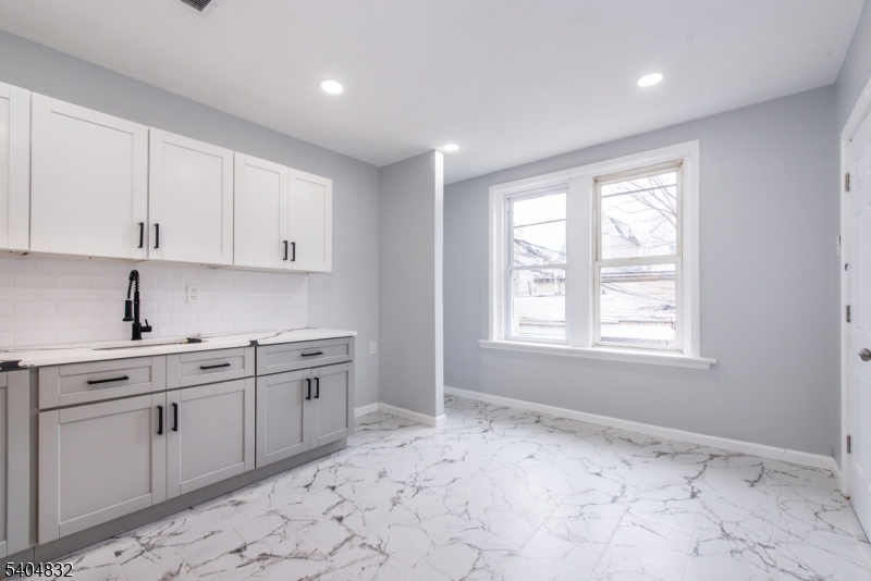 662 Mt Prospect Avenue Newark, NJ 07104 - Photo 8 of 15 a kitchen with a sink and cabinets