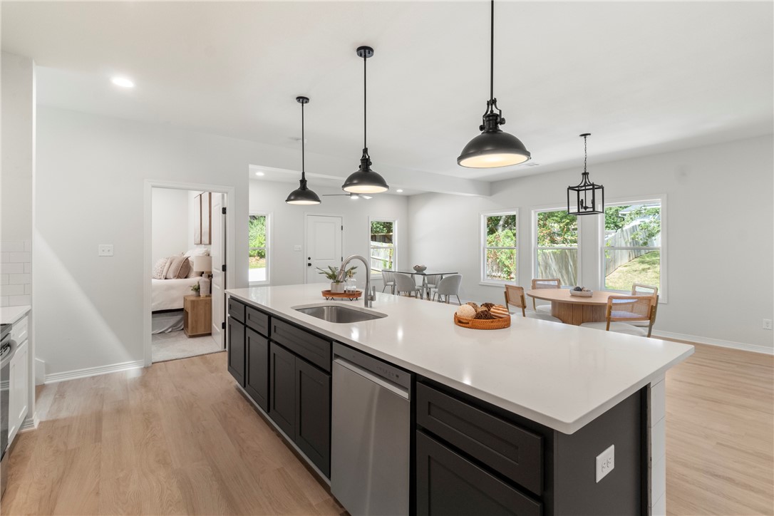 1104 Berkeley Street College Station, TX 77840 - Photo 26 of 44 a kitchen with sink cabinets and wooden floor