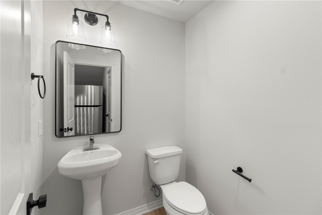 1104 Berkeley Street College Station, TX 77840 - Photo 27 of 44 a bathroom with a toilet sink and mirror