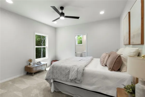 a bedroom with a bed a window and a couch