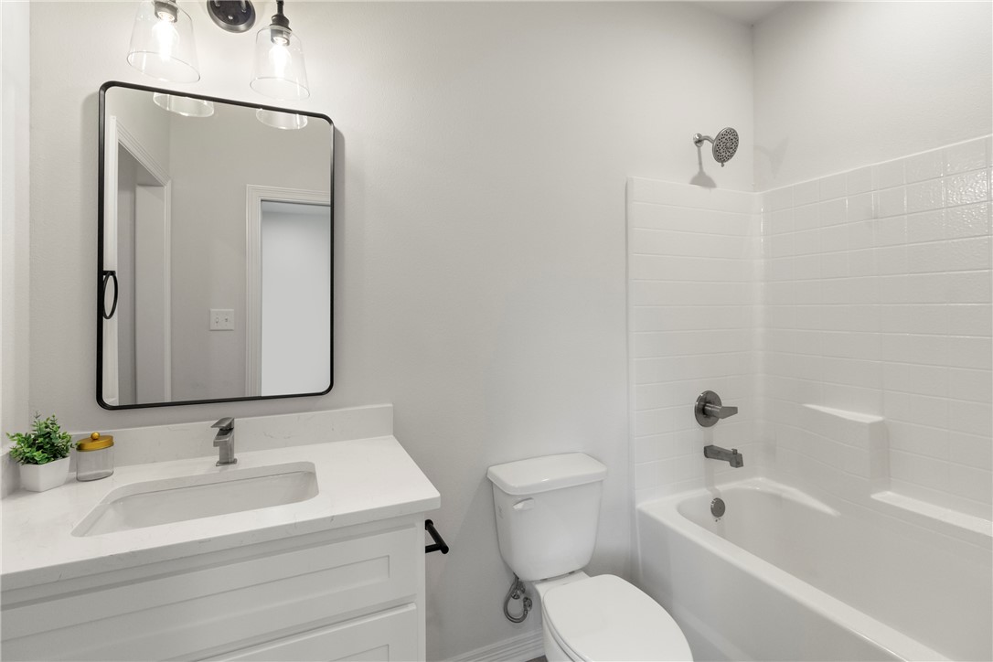 1104 Berkeley Street College Station, TX 77840 - Photo 40 of 44 a bathroom with a toilet a sink and a bathtub