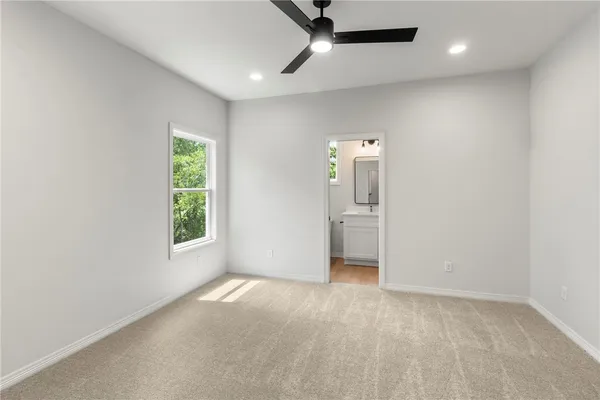 an empty room with windows and closet