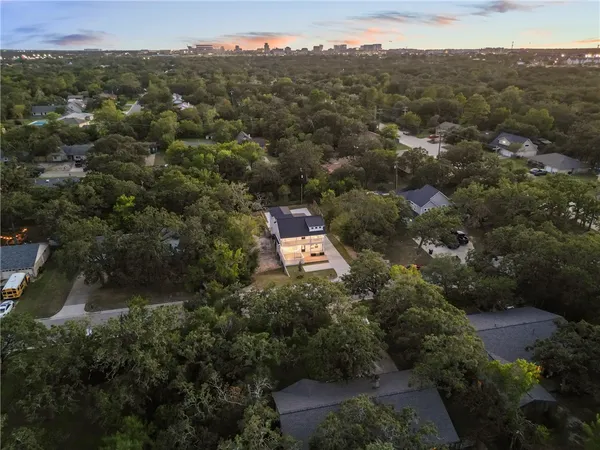 an aerial view of a house with a yard