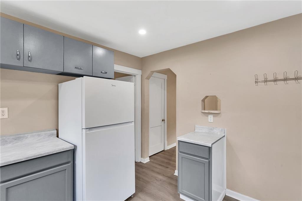 1048 Unity Trestle Road Pittsburgh, PA 15239 - Photo 5 of 27 a white refrigerator freezer sitting in a kitchen
