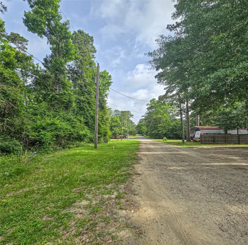 a view of a field with trees in the background