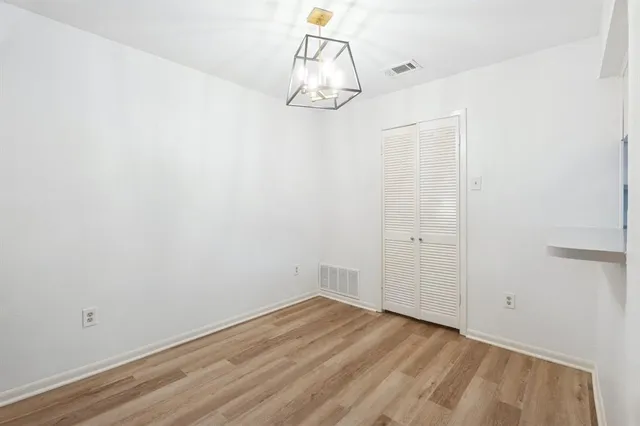a view of a room with wooden floor and white walls