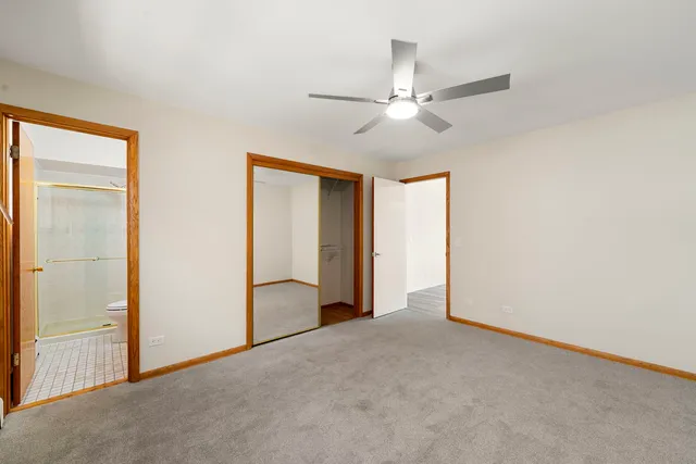 an empty room with fan and entryway