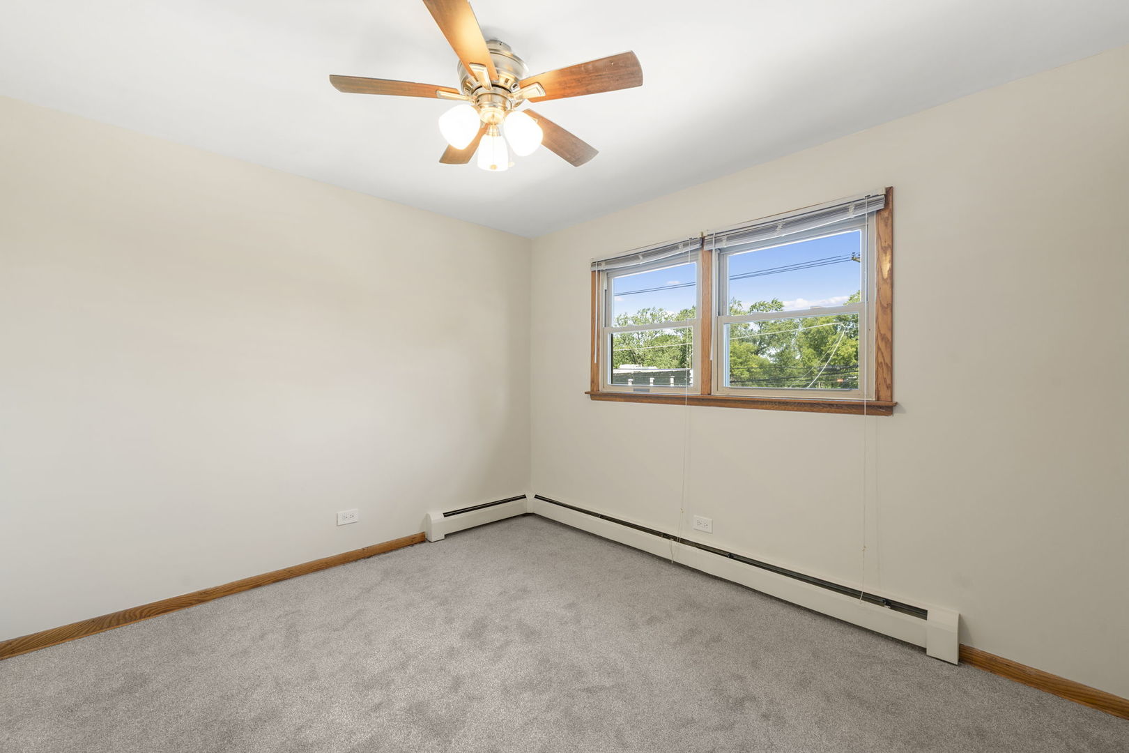 5400 West Dakin Street, Unit 1 Chicago, IL 60641 - Photo 19 of 20 an empty room with a window and a fan