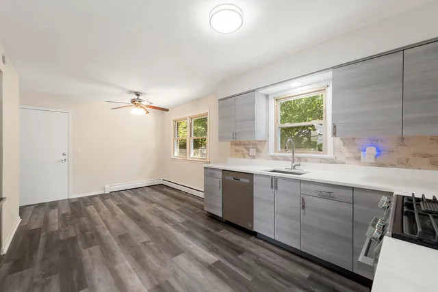 a view of kitchen with sink and window