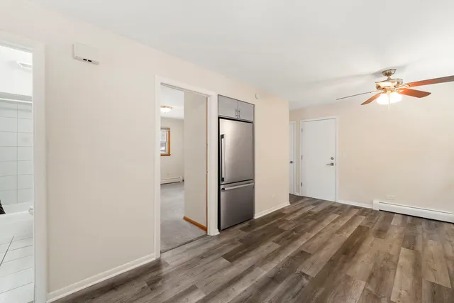 a view of a kitchen with wooden floor and a refrigerator in a kitchen