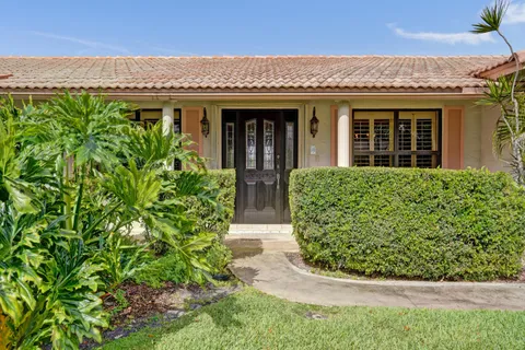 front view of a house with potted plants