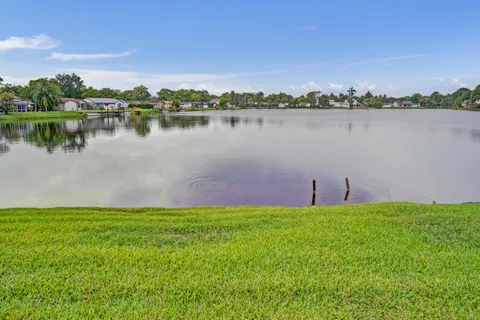 a view of a lake with houses in the background