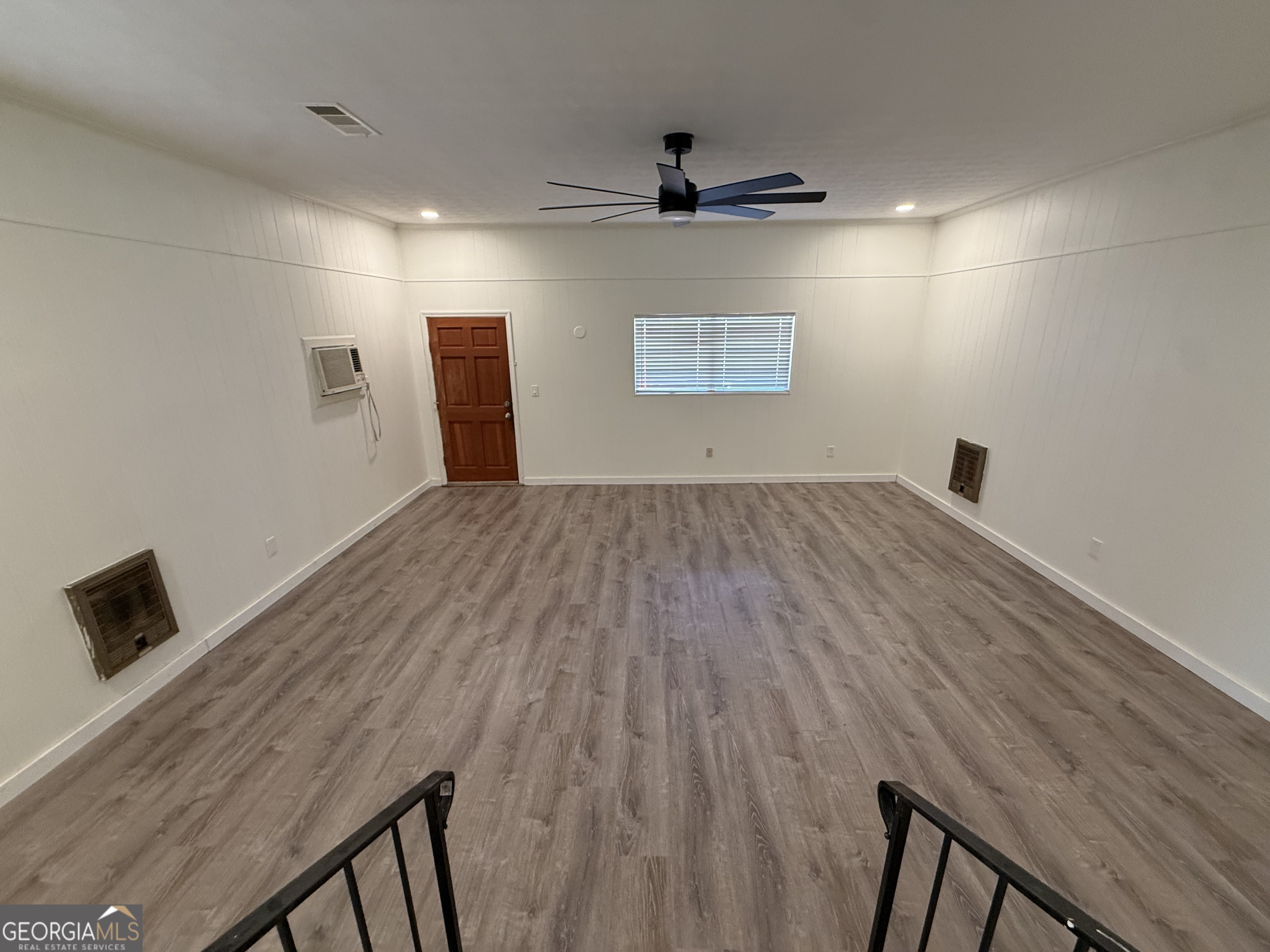 108 Plum Street Dublin, GA 31021 - Photo 30 of 33 an empty room with wooden floor and windows