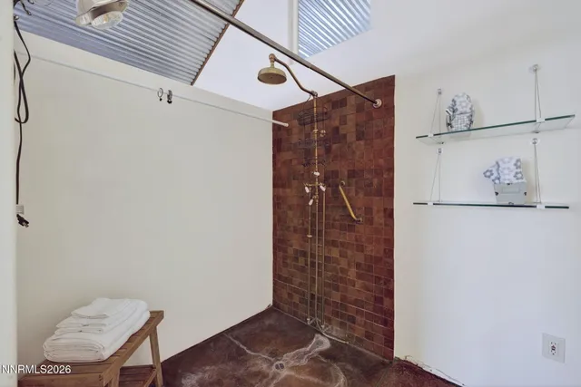 a bathroom with a granite countertop toilet sink and mirror