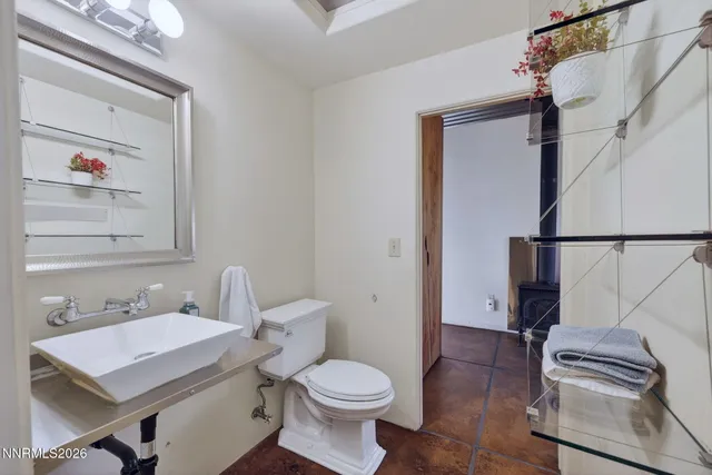 a bathroom with a sink toilet and mirror