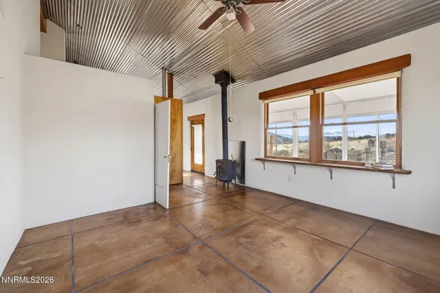 a view of a balcony with furniture and floor to ceiling window