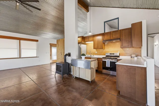 a kitchen with stainless steel appliances granite countertop a stove a refrigerator and a cabinets