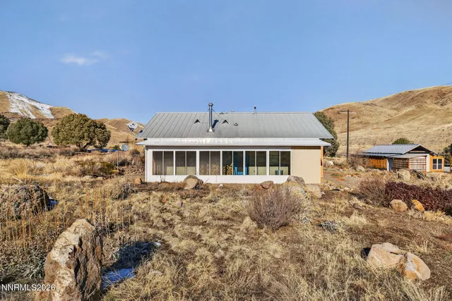 a backyard of a house with wooden fence