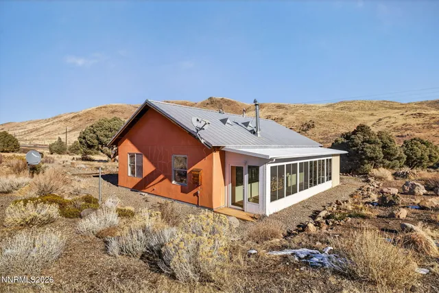 a view of a house with a yard and fence