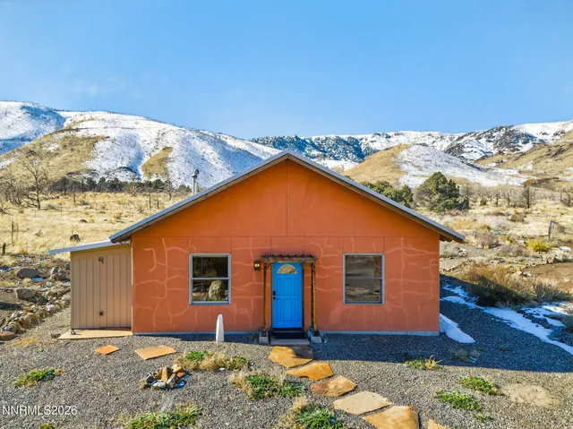 a view of a house with a mountain in the background