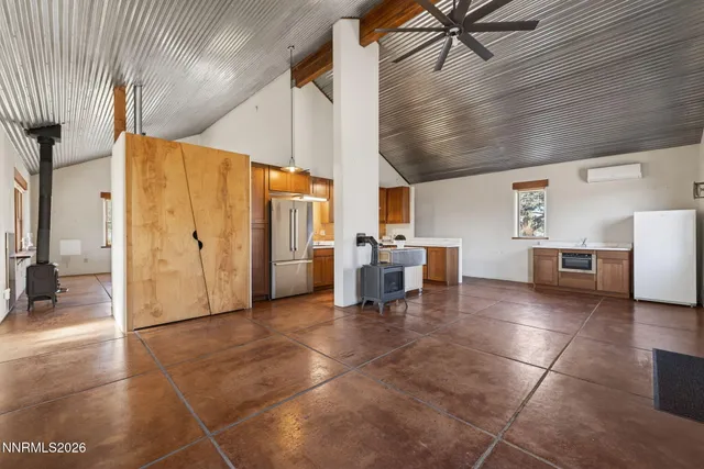a view of a livingroom with furniture and a kitchen