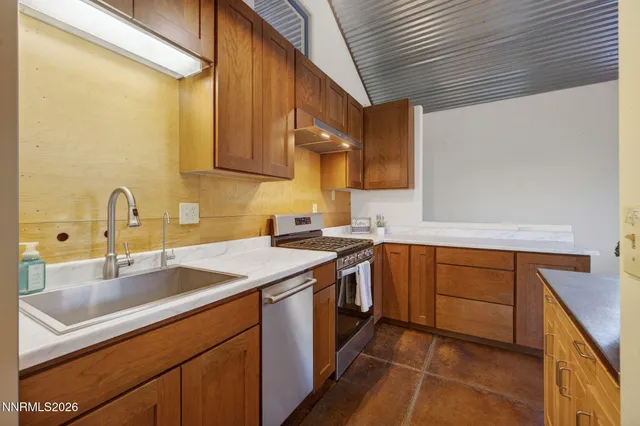 a kitchen with a sink stove and cabinets