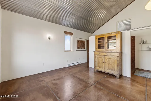 a view of an empty room with a kitchen