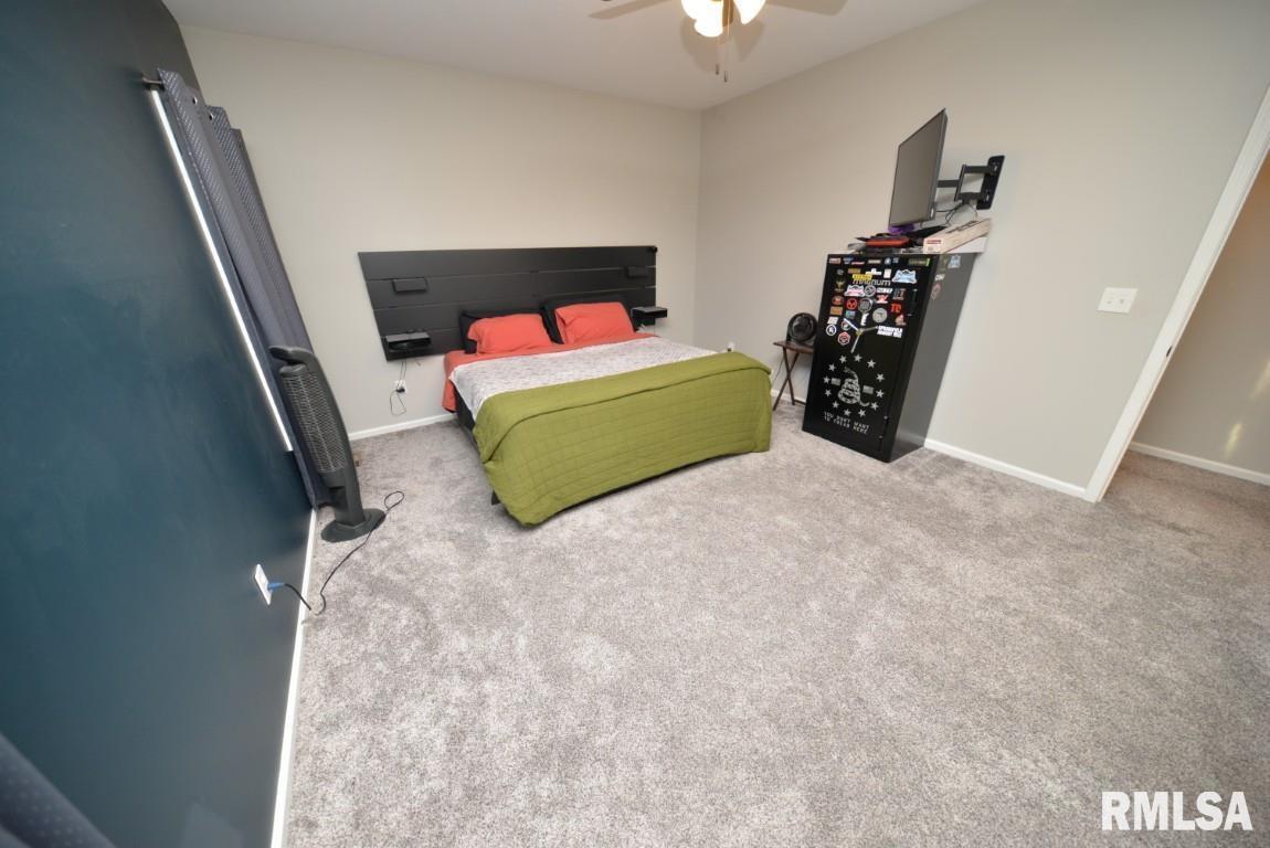 17359 Log Cabin Road Ewing, IL 62836 - Photo 22 of 38 a bedroom with a bed and a chandelier