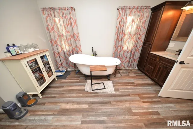 a bathroom with a sink a toilet a mirror and shower