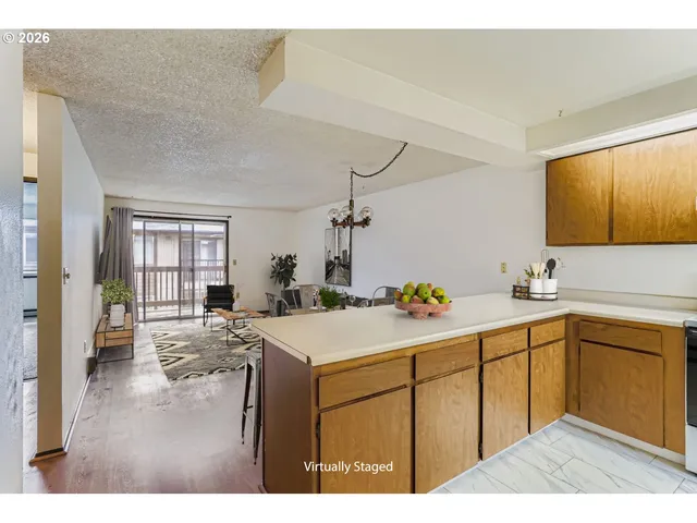 a kitchen with a sink cabinets and wooden floor