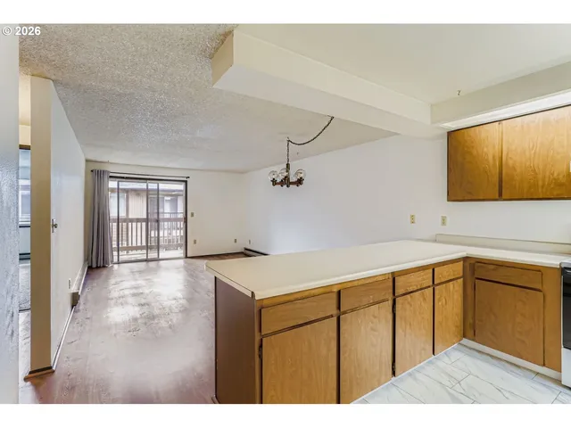 a kitchen with a sink a stove and cabinets